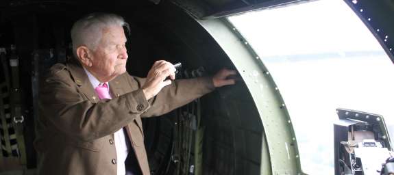 Bill Peterson, 506th Fighter Group, looks out from the window of a B-17 over Orlando.