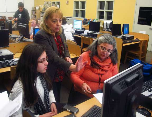 Miami Beach Senior High college adviser Maria Sahwell helps Anahi Hurtado, left, and her mother fill out the FAFSA. Credit John O'Connor / StateImpact Florida