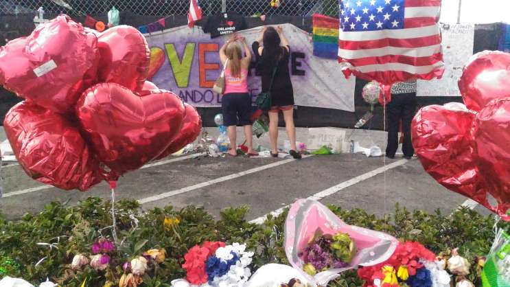People write messages at the memorial outside the Pulse nightclub. Photo: Matthew Peddie, WMFE