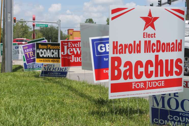 Campaign signs outside the Alafaya Library, one of Orange County's early voting sites. Photo: Matthew Peddie, WMFE