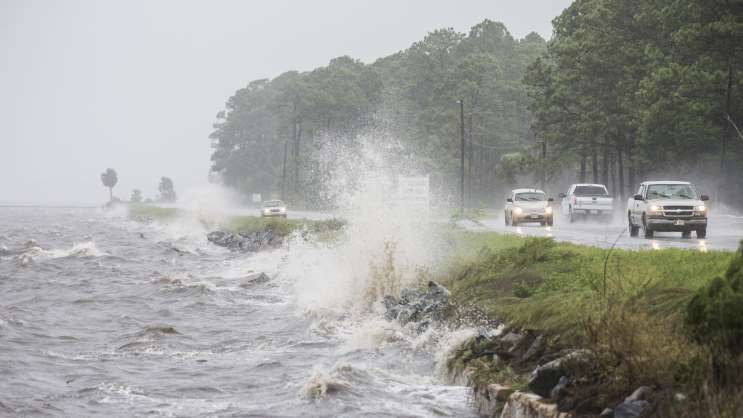Traffic moves along U.S. Highway 98 in Eastpoint, Fla., ahead of Hermine, which made landfall early Friday.