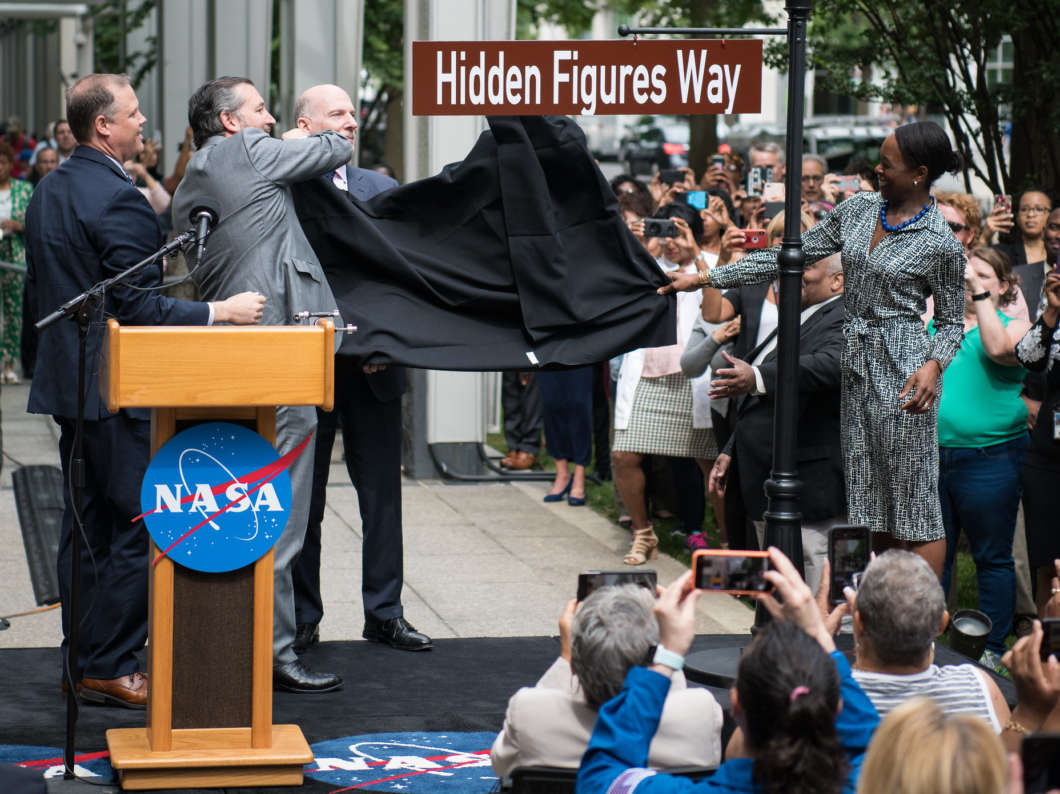 NASA Administrator Jim Bridenstine (from left), Sen. Ted Cruz, D.C. Council Chairman Phil Mendelson and Margot Lee Shetterly, author of the book Hidden Figures, unveil the Hidden Figures Way street sign at a dedication ceremony on Wednesday in Washington, D.C.
