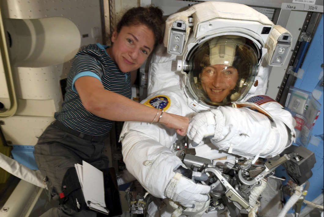 Astronauts Christina Koch (right) and Jessica Meir pose for a photo on the International Space Station on Oct. 4. NASA moved up the first all-female spacewalk because of a power system failure at the space station.