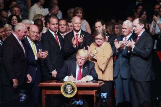 Then President Trump in Miami signing an order to re-tighten sanctions on Cuba in 2017. (Roberto Koltun/
Miami Herald)