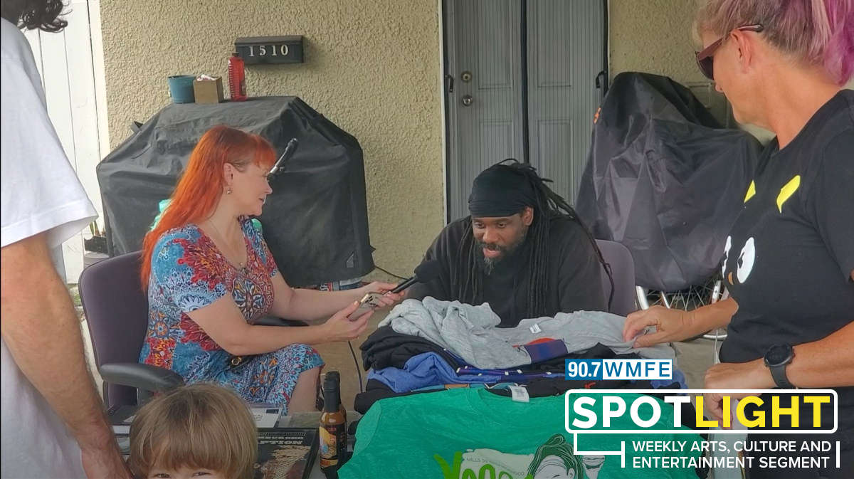 Swamburger (Asaan Brooks) speaks with Nicole Darden Creston as people browse wares at Swam's final yard sale before he leaves Orlando for good. Photo: Julian Bond